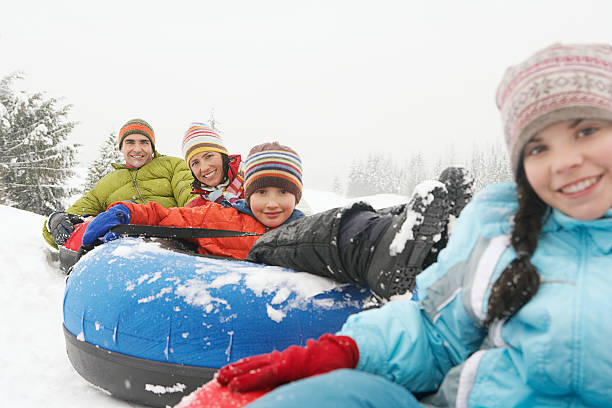 istock Family riding snow tubes 519161996