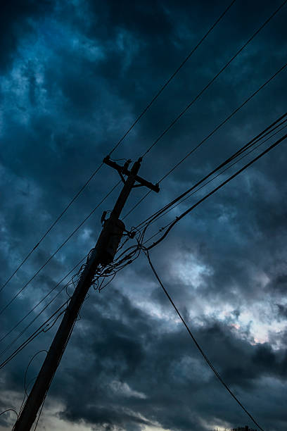 istock Leaning Telephone Pole with dark storm clouds moving in 519162560