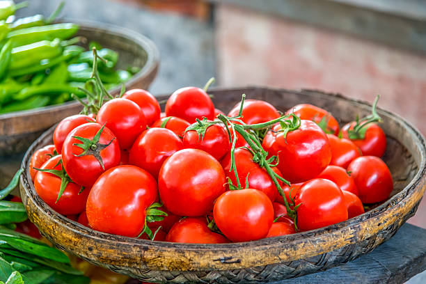 istock Organic Tomatoes in basket, market scene 519164008