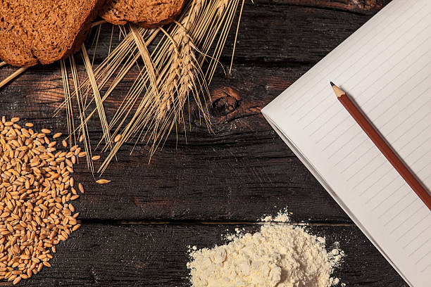 istock Spikelets of wheat and rye bread on a wooden table 519165468
