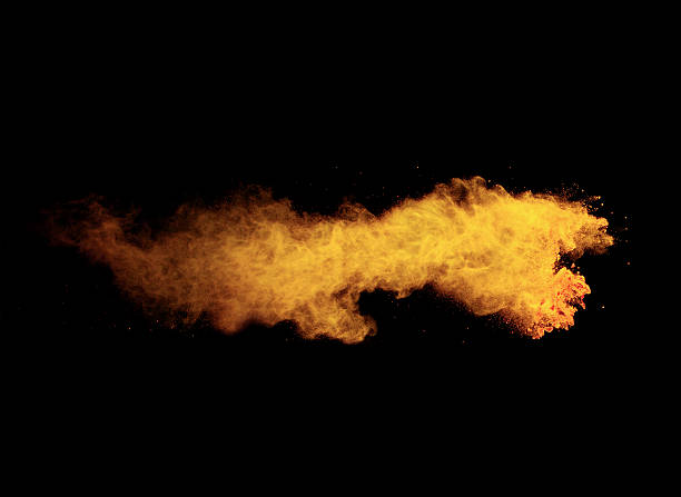 istock Explosion of yellow powder on black background 519165748