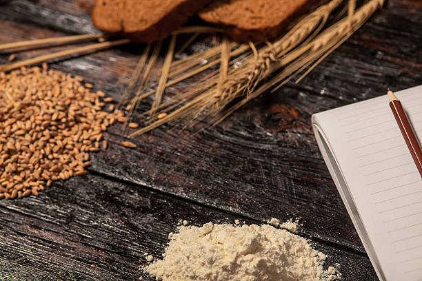 istock Spikelets of wheat and rye bread on a wooden table 519165808