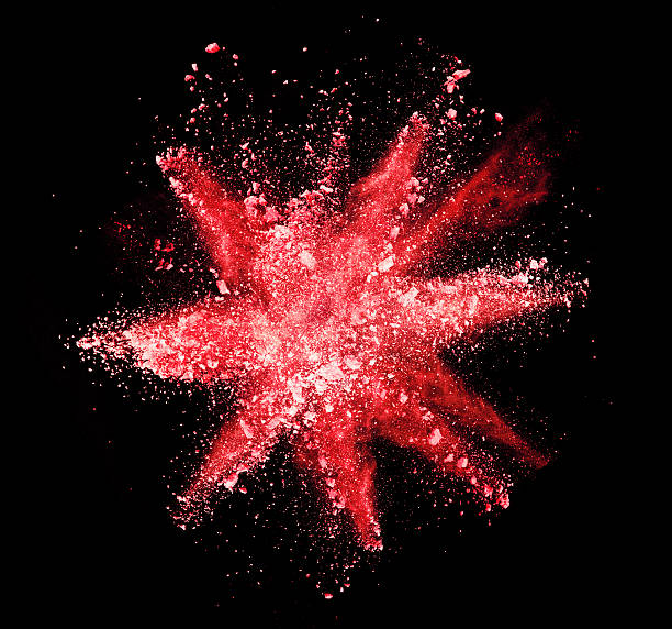 istock Explosion of red powder on black background 519166132