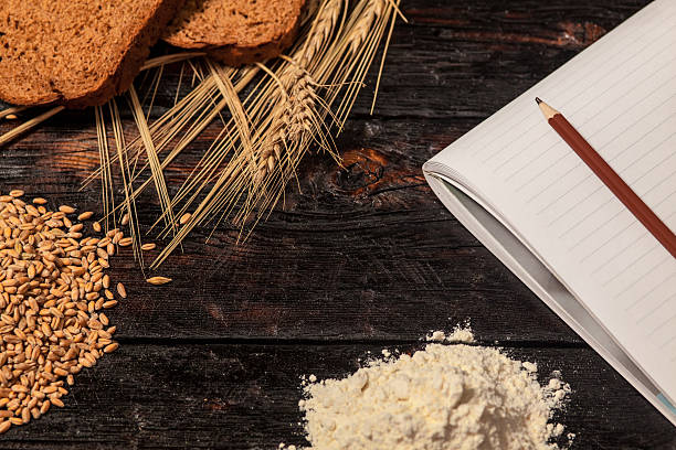 istock Spikelets of wheat and rye bread on a wooden table 519166632