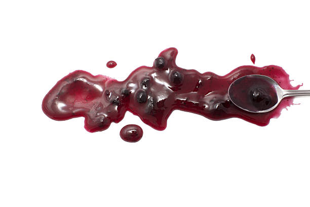 istock splashes, droplets and spilled blueberry jam with a spoon 519168456