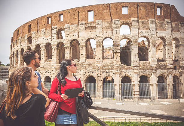 istock Tourists relaxing in front of the Coliseum, Rome 519169491