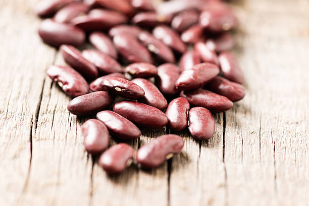 istock Red beans on wooden background close up 519171323