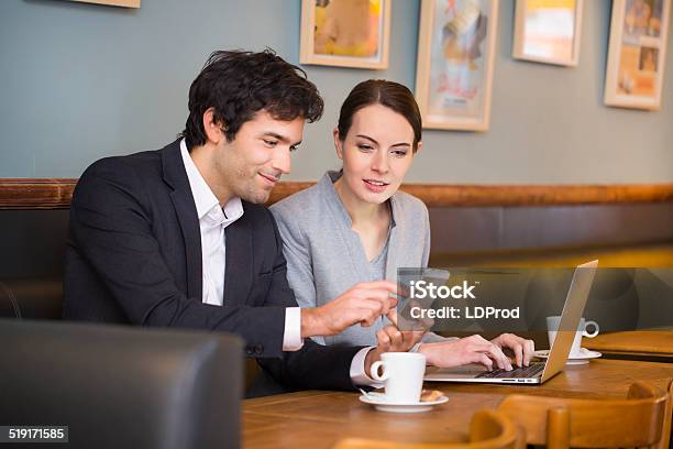 Young Couple Working On Laptop At Coffee Bar Stock Photo - Download Image Now - Business, Coffee - Drink, Two People