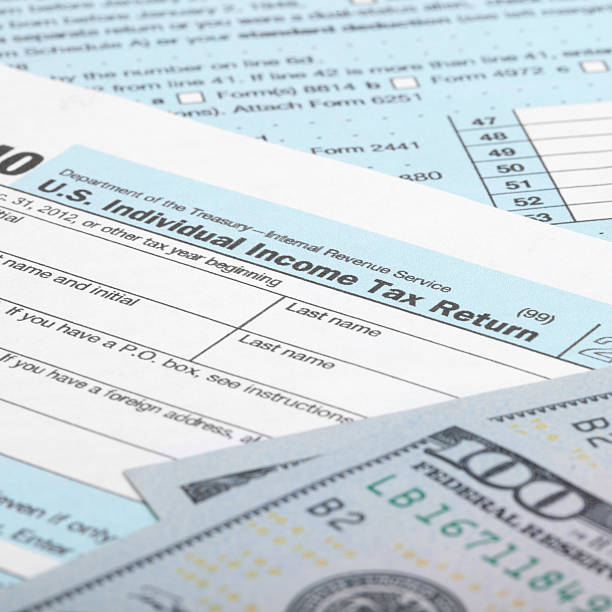 istock Tax Form 1040 with dollars - 1 to 1 ratio 519172639