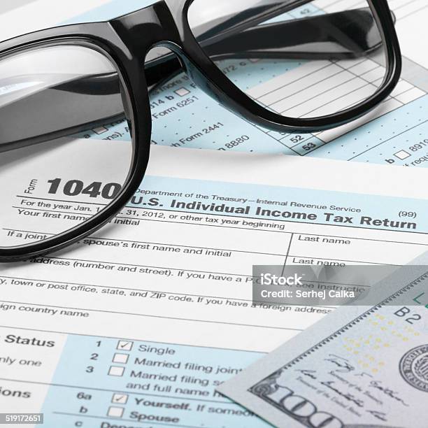 Tax Form Dollars And Glasses 1 To 1 Ratio Stock Photo - Download Image Now - 1040 Tax Form, April, Balance