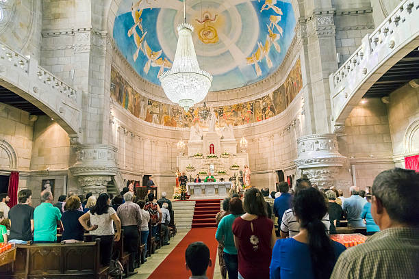 Viana do Castelo, Portugal - October, 19th 2014: People at church service inside Santa Luzia church, a Neo Byzantine church up on a hill, which is a place of pilgrimage. It can be reached by foot, car and by a funicular which leaves from near the station. 