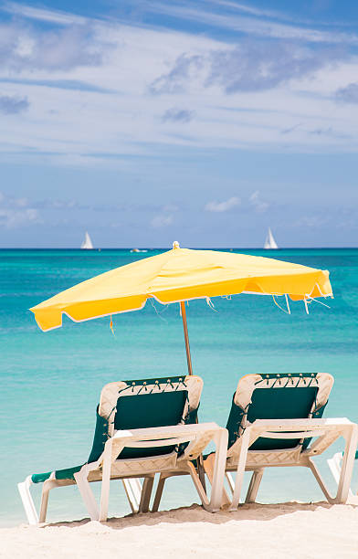istock Green Chairs Under Yellow Umbrella in Paradise 519175219