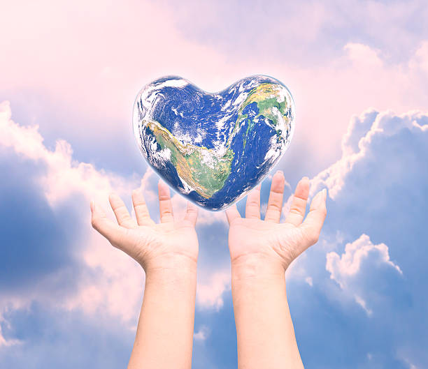 istock World in heart shape with over women human hands 519182288