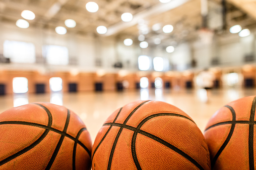 A basketball on basketball court with no people around. Concept of training, teamwork, team spirit and competition. A ball on basketball court, sports equipment only without people. Copy space.