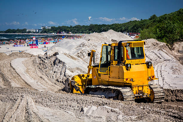 Loader Excavator standing on a pile of sand by the sea in Istanbul, Turkey.