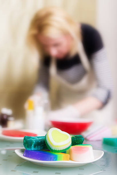 Woman is making a handmade soap, selective focus on foreground