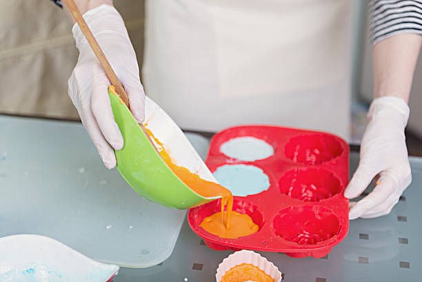 istock Woman's hands in the process of homemade soap preparation 519183482