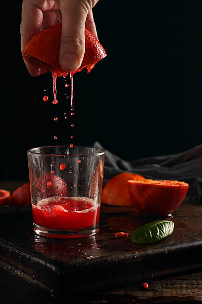 istock Squeezing the juice of blood oranges 519184144