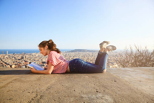 Child reading over the city of Barcelona