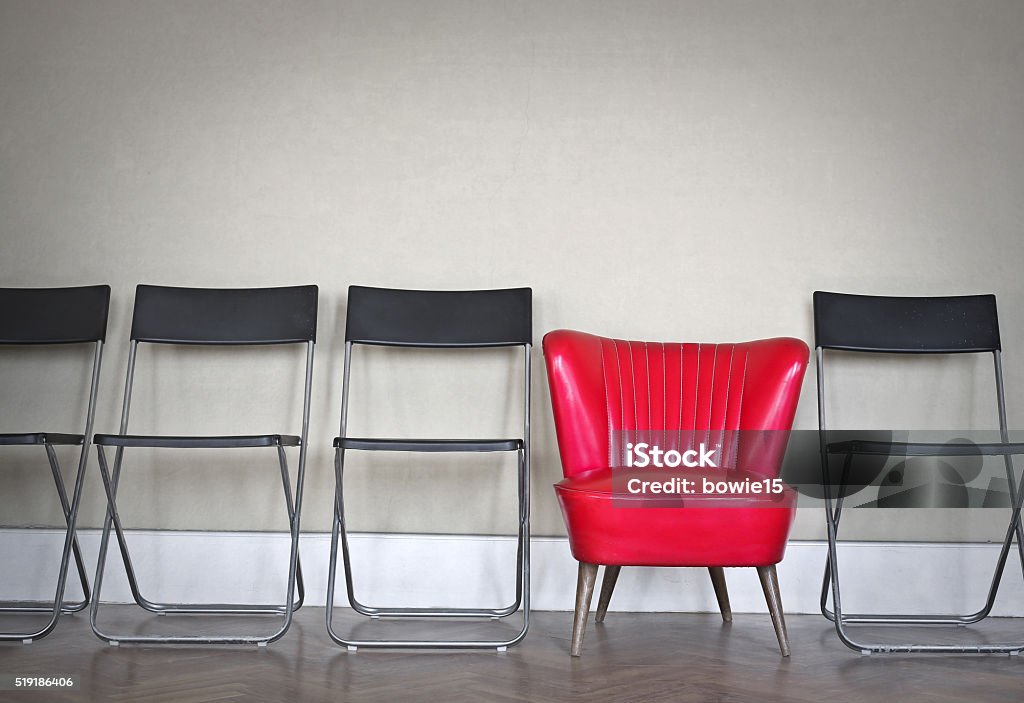 Different armchair Different armchair, red between black ones Contrasts Stock Photo