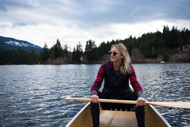 istock Female canoeing on a prisitine lake 519186826