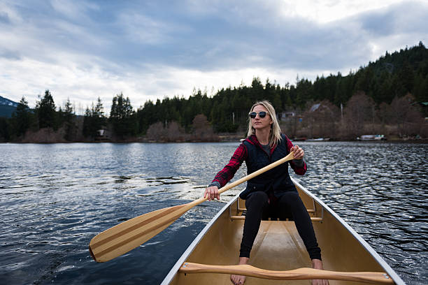 istock Female canoeing on a prisitine lake 519187080