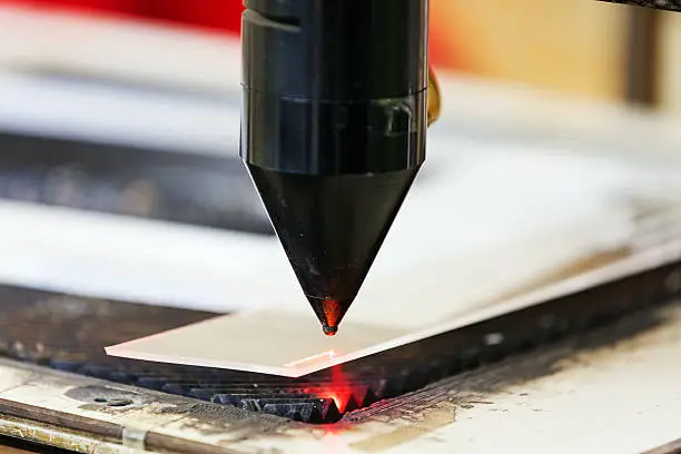 Red laser on cutting machine in physics laboratory