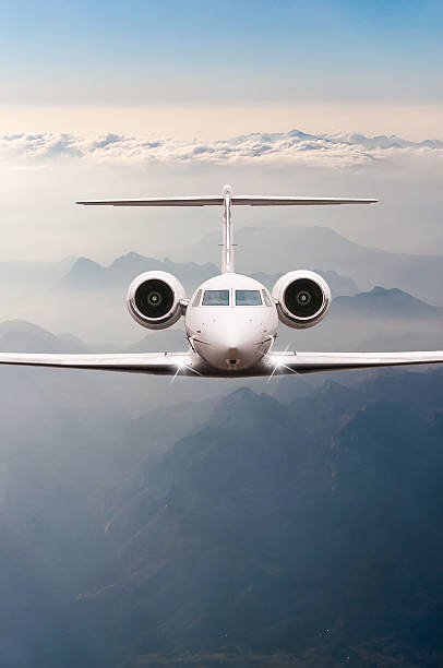 istock Airplane fly over clouds and Alps mountain on sunset. Front 519190906