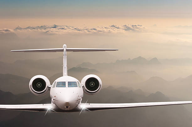 istock Airplane fly over clouds and Alps mountain on sunset. Front 519190936