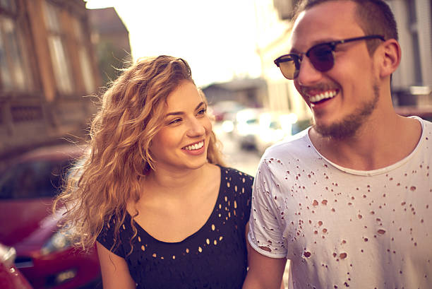 Lovely young couple Young happy couple wearing urban casual clothes and having fun in the city. couple tease stock pictures, royalty-free photos & images