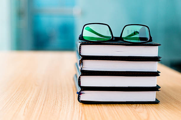 istock Books and glasses on desk 519192418