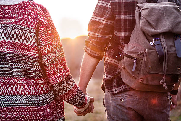 istock Hiking couple looking at the sunset, holding hands 519193334