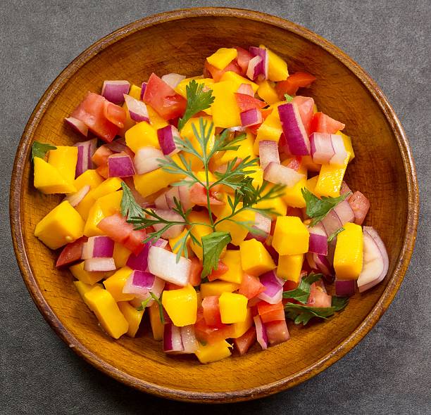 istock Homemade Mango salsa served in a wooden plate top view 519196304