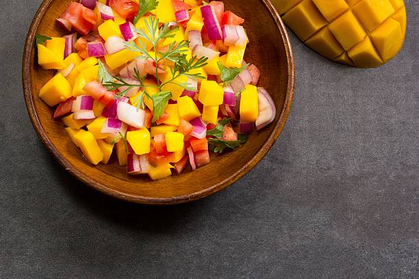 istock Homemade Mango salsa served in a wooden plate 519196386
