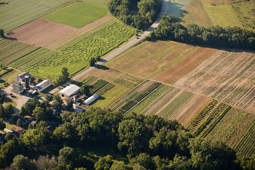 Aerial view of a generic organic farm in Indiana, USA. Corn maze and multiple crops growing.