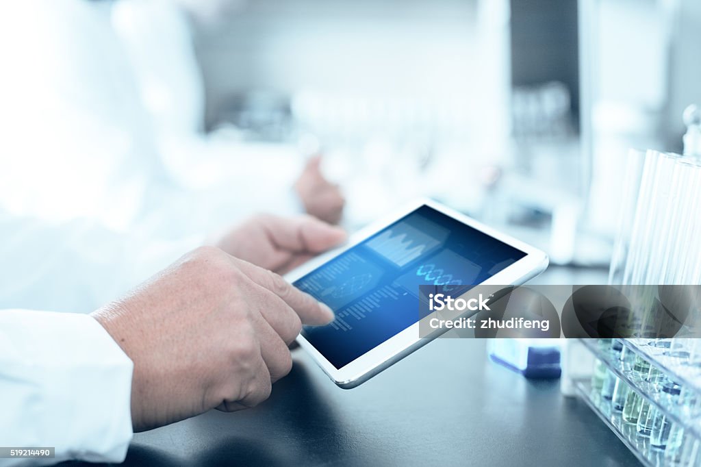 people analysis chemical experiment by tablet in modern lab Laboratory Stock Photo