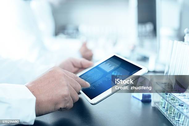 People Analysis Chemical Experiment By Tablet In Modern Lab Stock Photo - Download Image Now