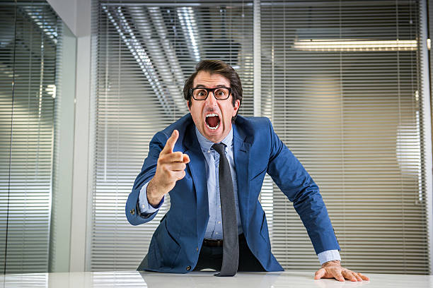 Angry Nerdy Boss Yelling Nerdy caucasian mid thirties businessman in glasses yelling. bossy stock pictures, royalty-free photos & images