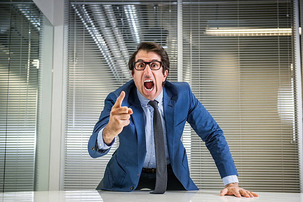 Angry Nerdy Boss Yelling Nerdy caucasian mid thirties businessman in glasses yelling. foreman stock pictures, royalty-free photos & images