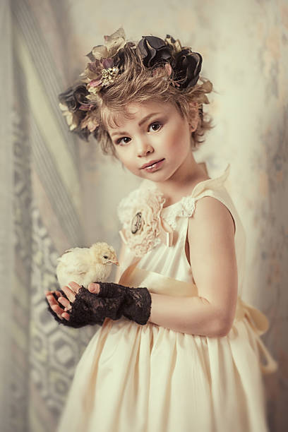 istock girl holding a chicken in his hands 519217152