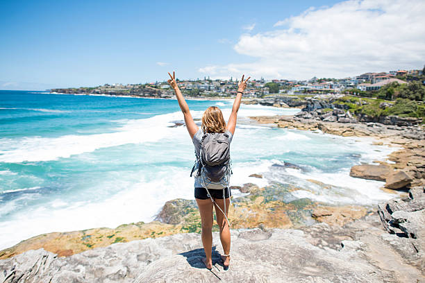 istock Female solo backpacker traveller on cliff Australian Beach 519217390
