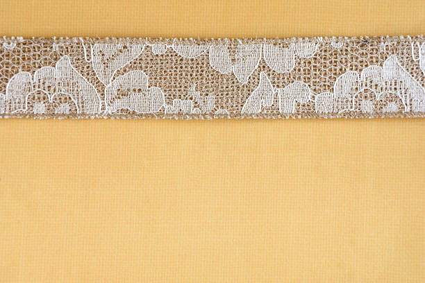 Gold peach lace sits on a gold silk background