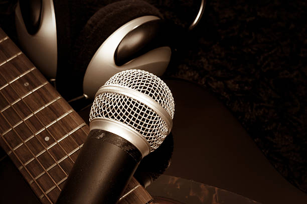 istock dynamic microphone on acoustic guitar with headphone on black carpet 519217844