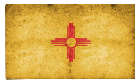A stock photo of the New Mexico state flag in the USA. High resolution on a worn out grunge style textured background.