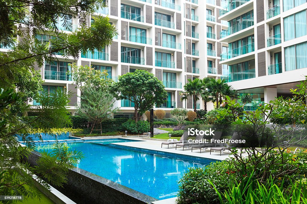 Swimming pool mit apartment houses in the background Swimming pool mit apartment houses in the background and garden in Chiang Mai, Thailand Apartment Stock Photo