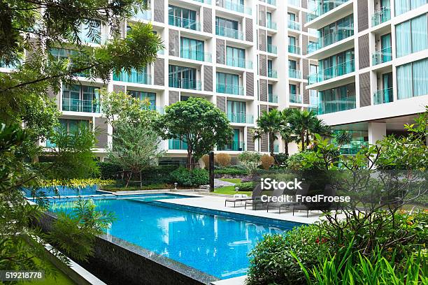 Swimming Pool Mit Apartment Houses In The Background Stock Photo - Download Image Now