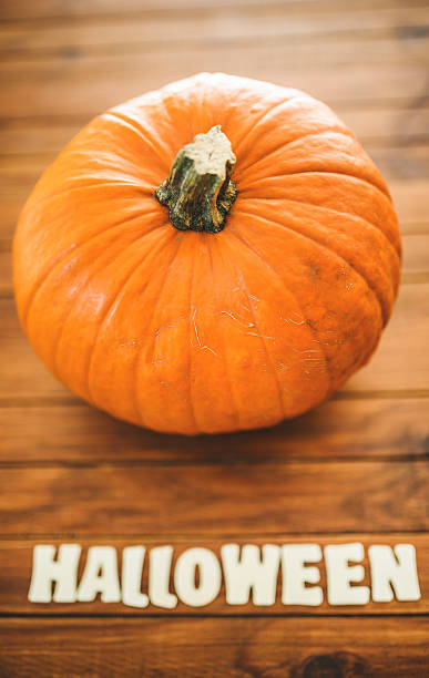 istock halloween pumpkin on rustic wood 519219795