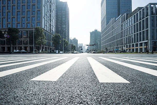 istock empty asphalt road through modern business buildings 519220666