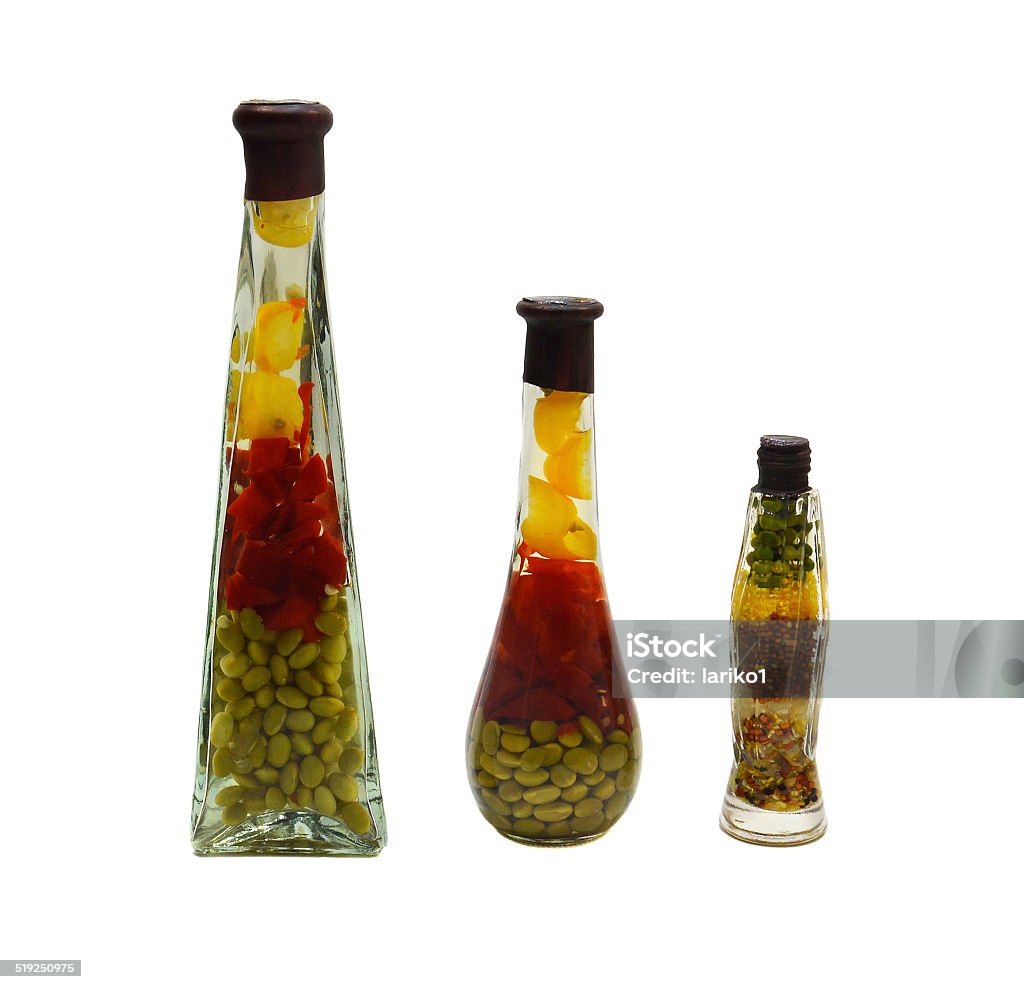 Decorative bottle Bottles filled with grains and vegetables, plenty of clear liquid. Photo taken on a white background. Art Stock Photo