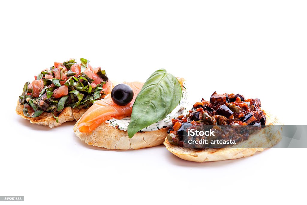 Bruschetta, 19 Bruschette, traditional italian appetizer food with tomato, with salmon and eggplant on a white background Antipasto Stock Photo